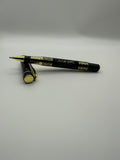 Black eyeliner pen with gold accents on a white background