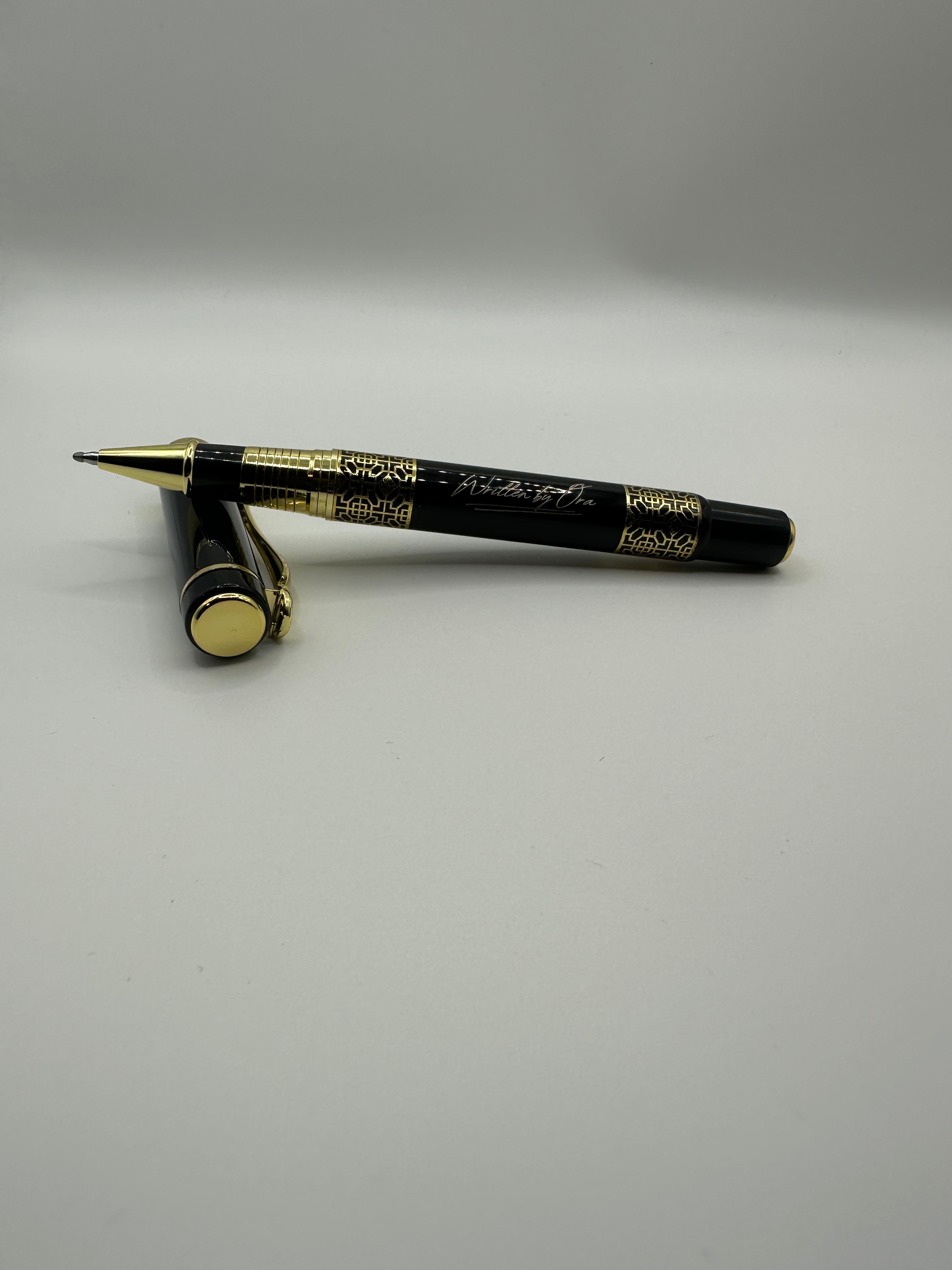 Black eyeliner pen with gold accents on a white background