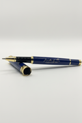 Written by Ora luxury rollerball pen with polished gold accents and black lacquer finish