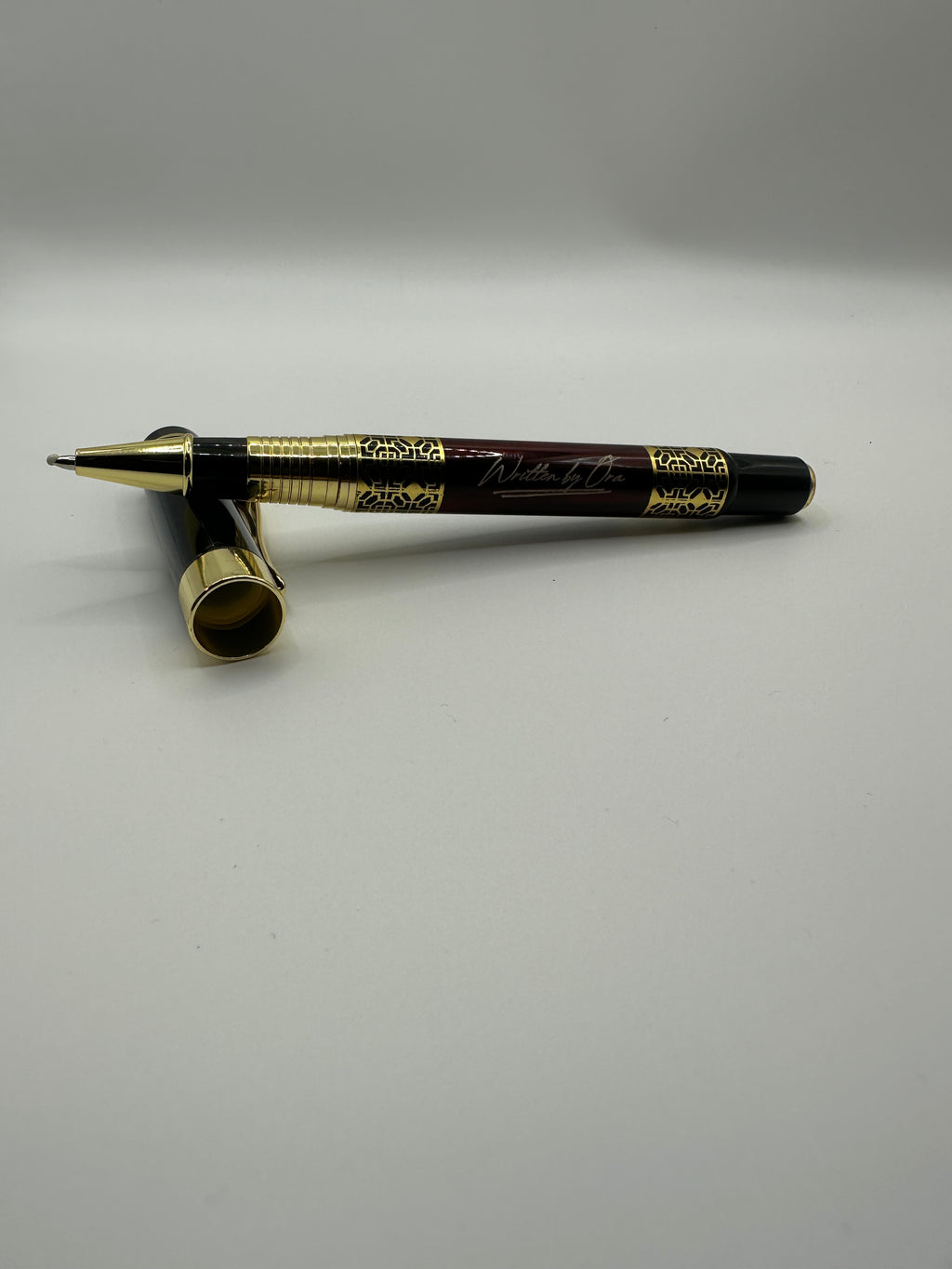 Written by Ora luxury rollerball pen with polished gold accents and black lacquer finish