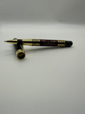 Written by Ora luxury rollerball pen with polished gold accents and black lacquer finish